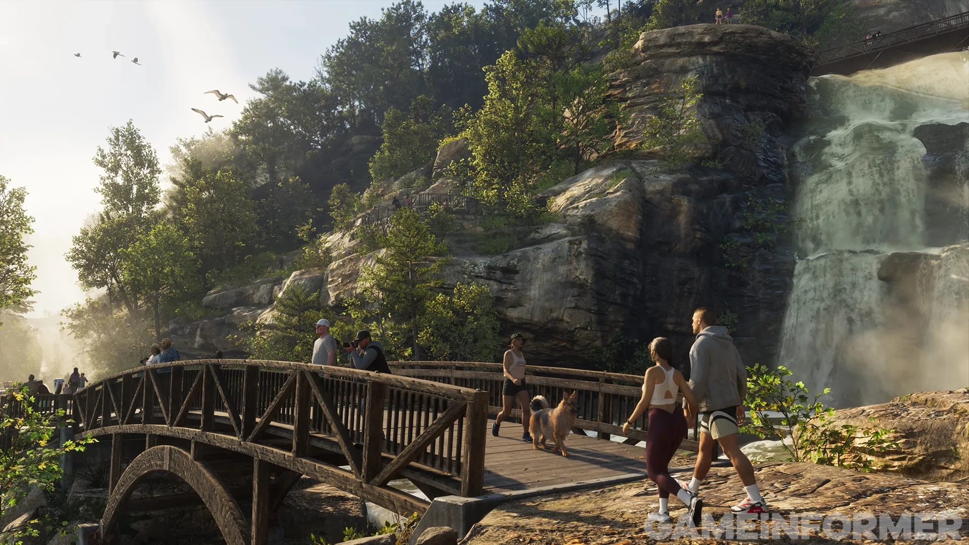Pedestrians, hikers, and a dog walking across a wooden bridge near a large cascading waterfall in a lush mountain state park in Grand Theft Auto VI.