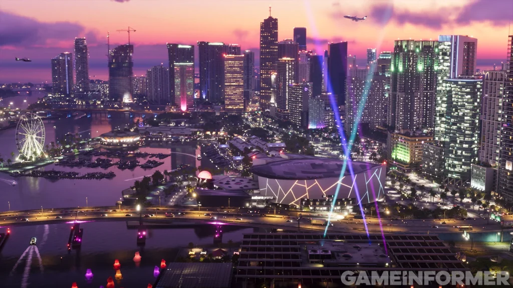 Aerial view of the illuminated Vice City skyline at dusk in Grand Theft Auto VI featuring Vice City Marina, a Ferris wheel, spotlights over the arena, and skyscrapers.